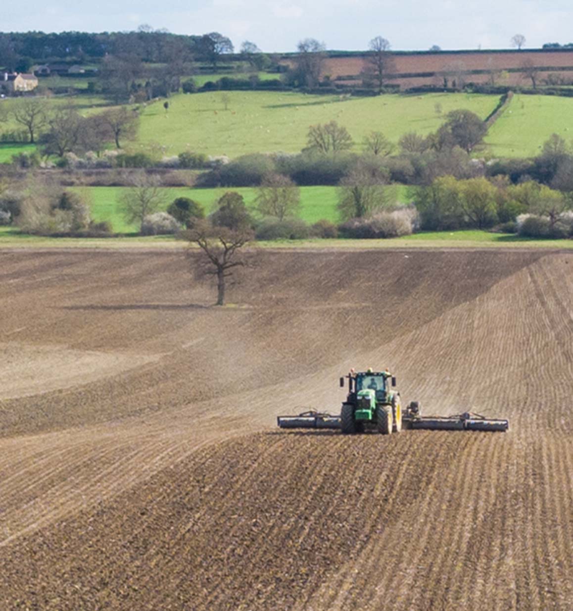 John Deere 6215 & 12m Dalbo Rolls - GPS guided consolidation of a strip-till drilled field (note the ridges).